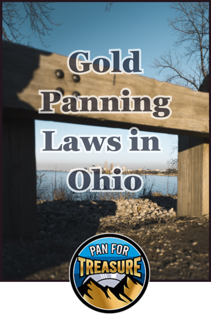 A wooden beam frames a rocky lakeshore scene with city buildings in the distance. Text reads: "Gold Panning Laws in Ohio—Know Before You Pan." A logo at the bottom says "Pan for Treasure.