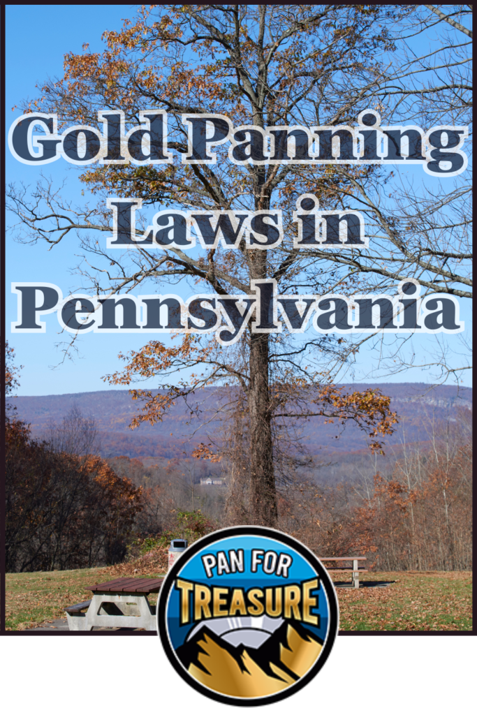 A tree stands in a park with autumn leaves and hills in the background. Text reads "Gold Panning Laws in Pennsylvania," highlighting key regulations. The "Pan For Treasure" logo is featured at the bottom.