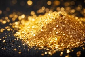 A close-up of a pile of gold glitter scattered on a dark surface, with light reflecting off the small, shiny particles—highlighting the challenges of fine gold recovery amid such delicate materials.